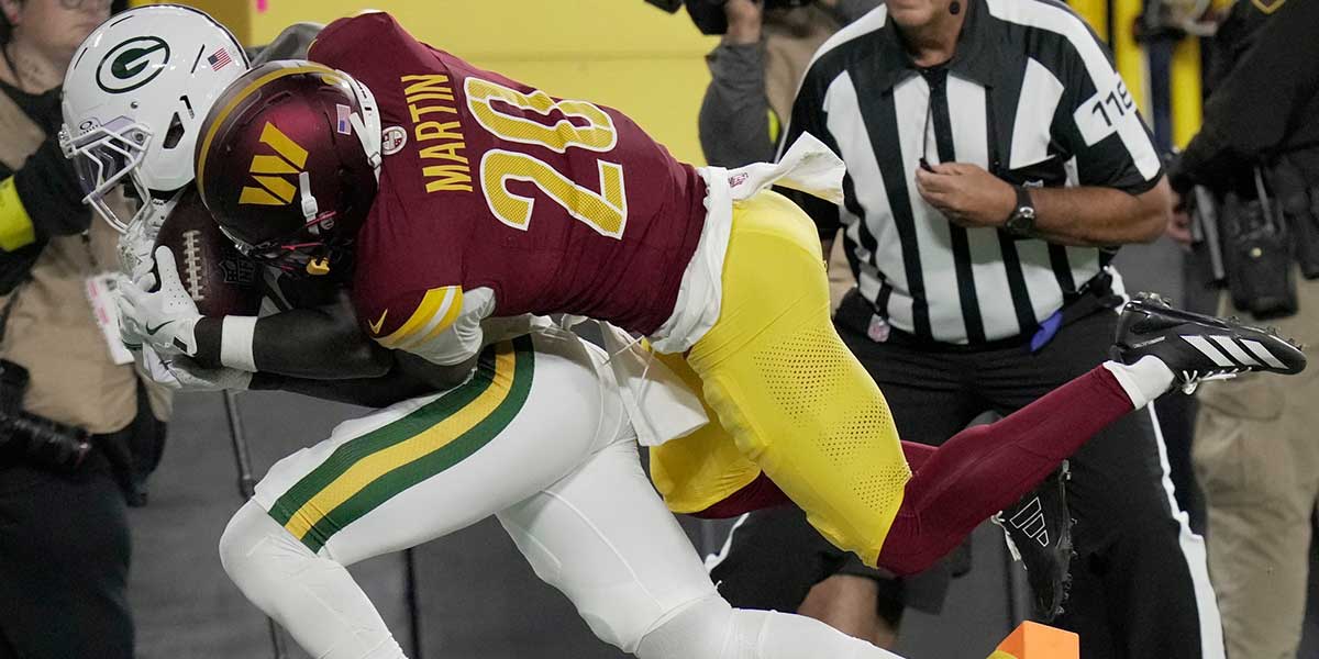Green Bay Packers wide receiver Jayden Reed (11) is injured while being tackled by Washington Commanders safety Quan Martin (20) during the first quarter of their game Thursday, September 11, 2025 at Lambeau Field in Green Bay, Wisconsin.