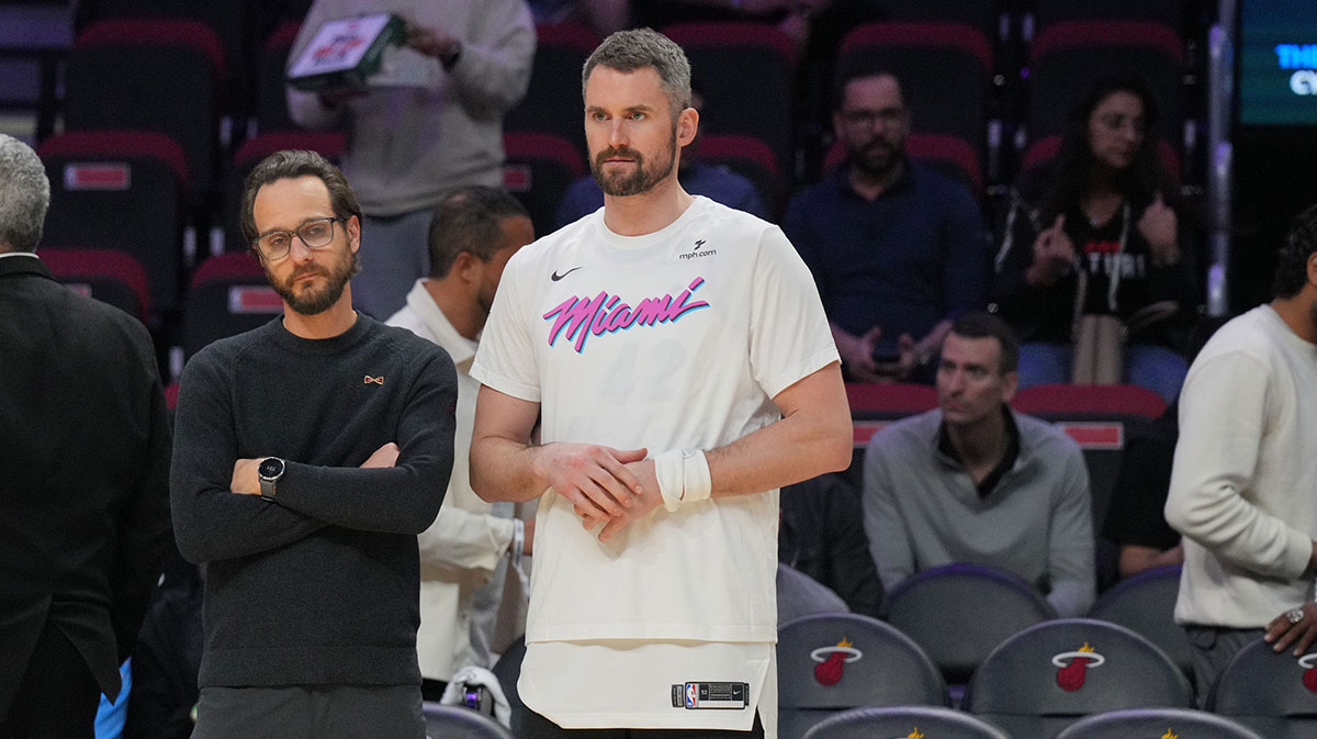 Heat forward Kevin Love (42) looks on during warm-ups before the game against the Cleveland Cavaliers at Kaseya Center with Jazz training camp in the background