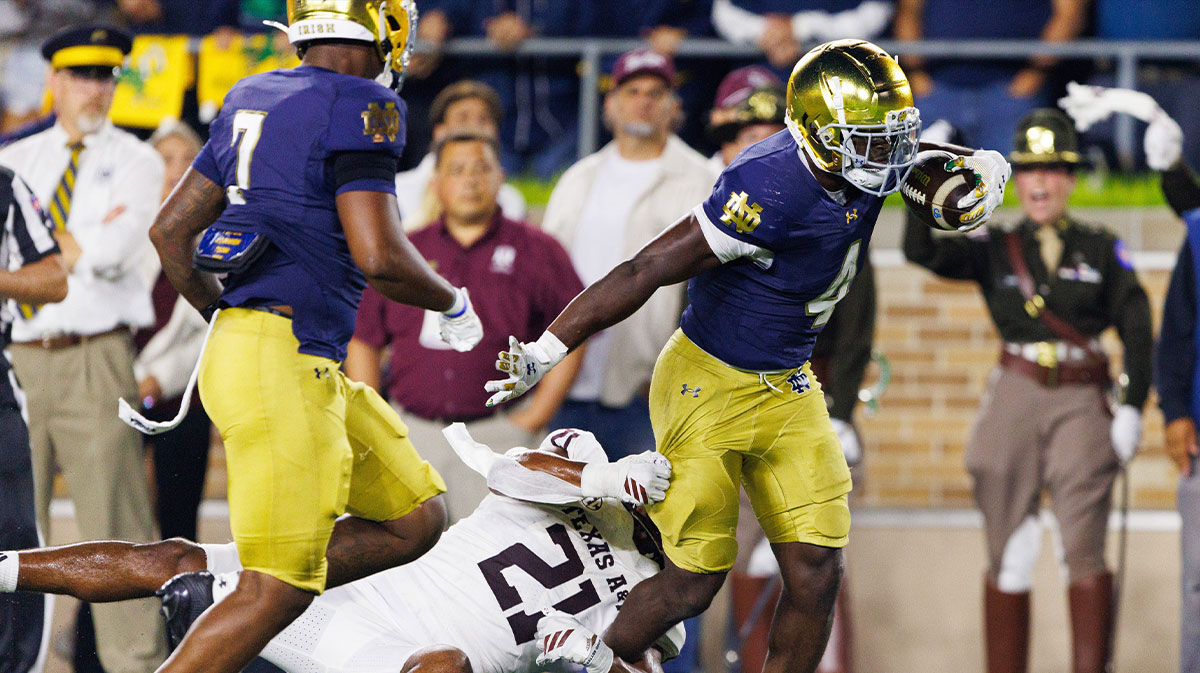 Notre Dame running back Jeremiyah Love (4) runs through a tackle attempt by Texas A&M linebacker Taurean York (21) to score a touchdown in the second half of a NCAA football game at Notre Dame Stadium