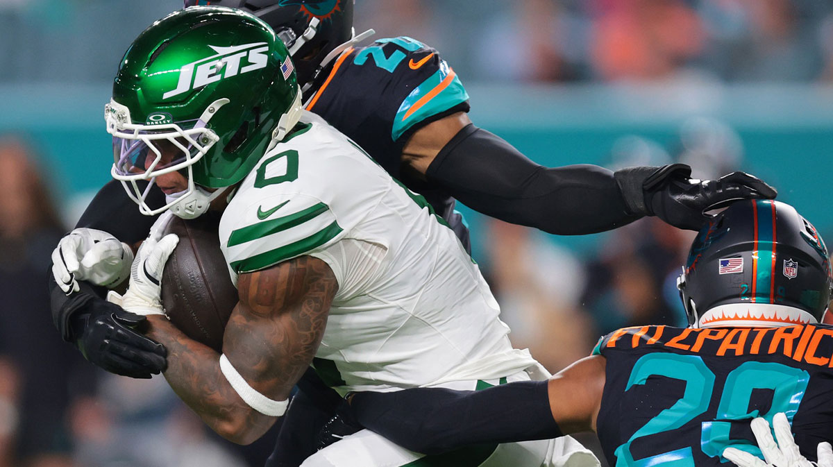 New York Jets running back Braelon Allen (0) rushes the ball against Miami Dolphins defensive back Elijah Campbell (22) during the first half at Hard Rock Stadium.
