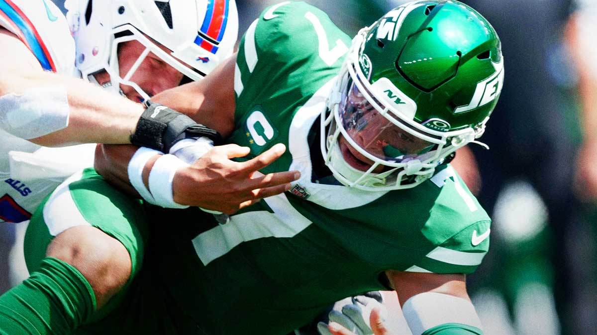 New York Jets quarterback Justin Fields (7) loses control of the ball after running and being tackled by Buffalo Bills defensive end Joey Bosa.