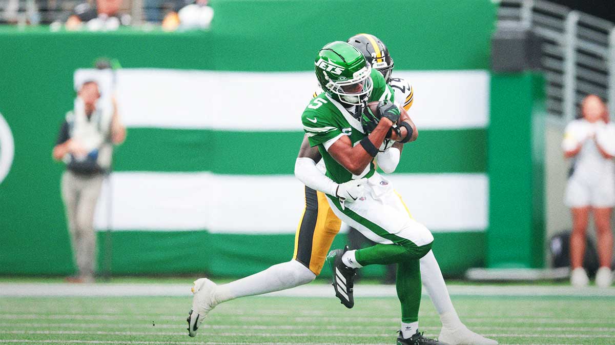 New York Jets wide receiver Garrett Wilson (5) is tackled by Pittsburgh Steelers cornerback Joey Porter Jr. (24) during the second quarter at MetLife Stadium.
