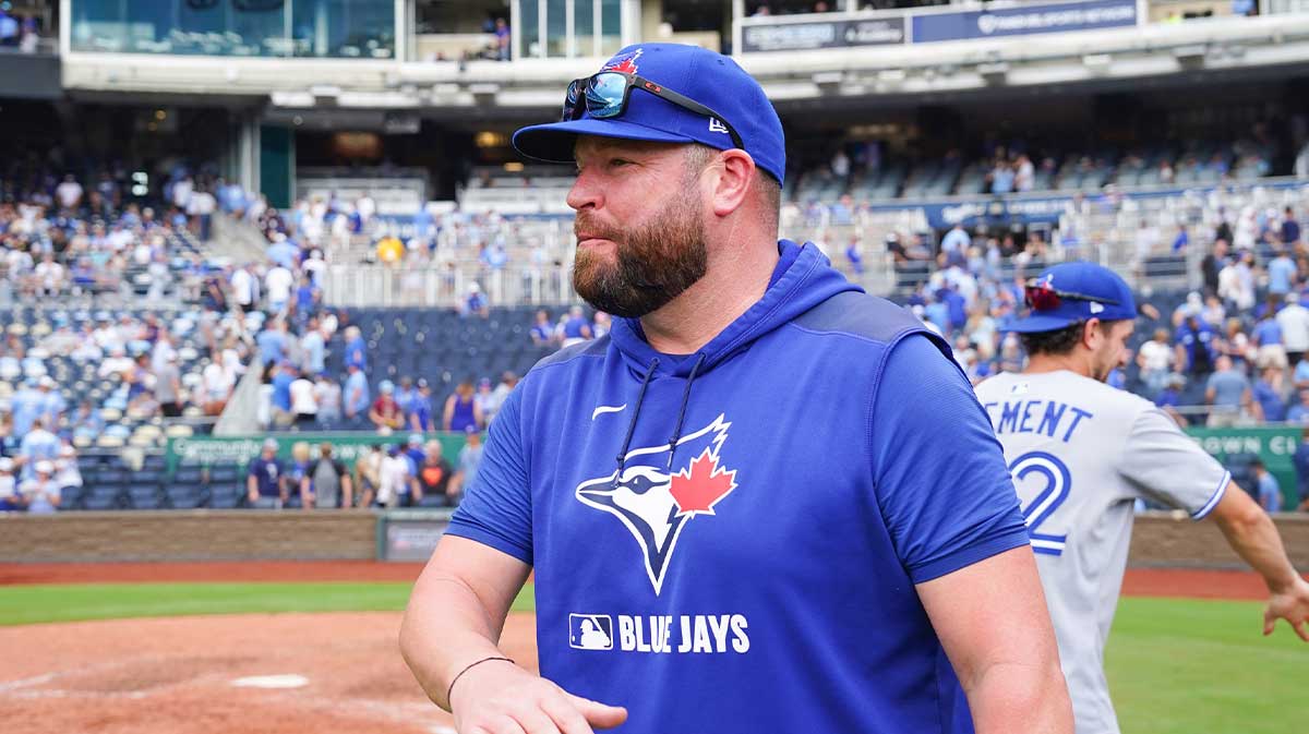 Toronto Blue Jays manager John Schneider (14) congratulates players on field after the win over the Kansas City Royals at Kauffman Stadium. 