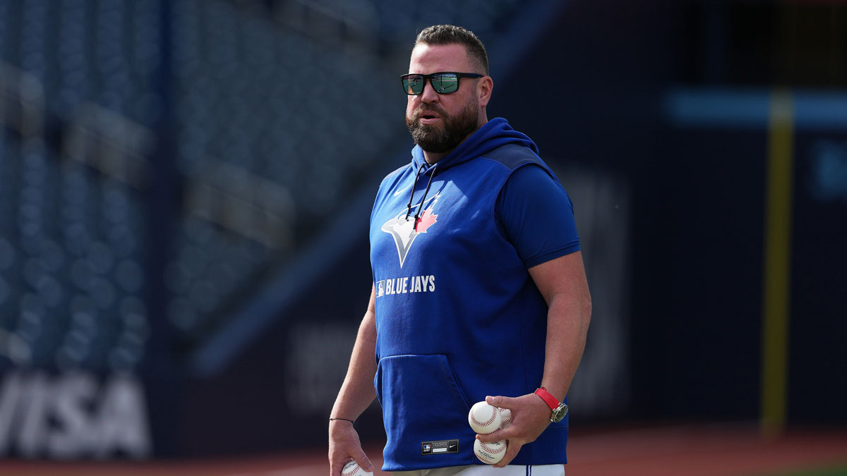 Toronto Blue Jays manager John Schneider (14) throws balls during batting practice before a game against the Minnesota Twins at Rogers Centre.
