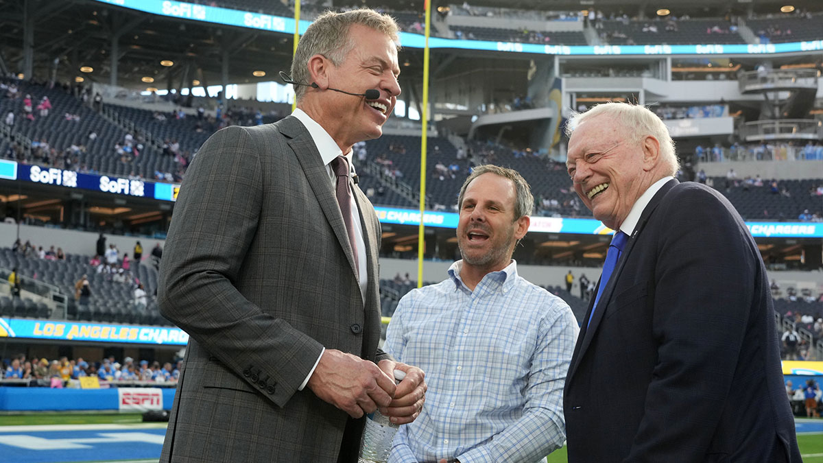 Dallas Cowboys former quarterback Troy Aikman (center), Los Angeles Chargers vice chairman Michael Spanos (center) and Cowboys owner Jerry Jones talk at SoFi Stadium.