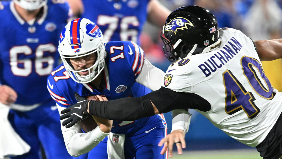 Buffalo Bills quarterback Josh Allen (17) runs the ball defended by Baltimore Ravens linebacker Teddye Buchanan (40) during the third quarter at Highmark Stadium.