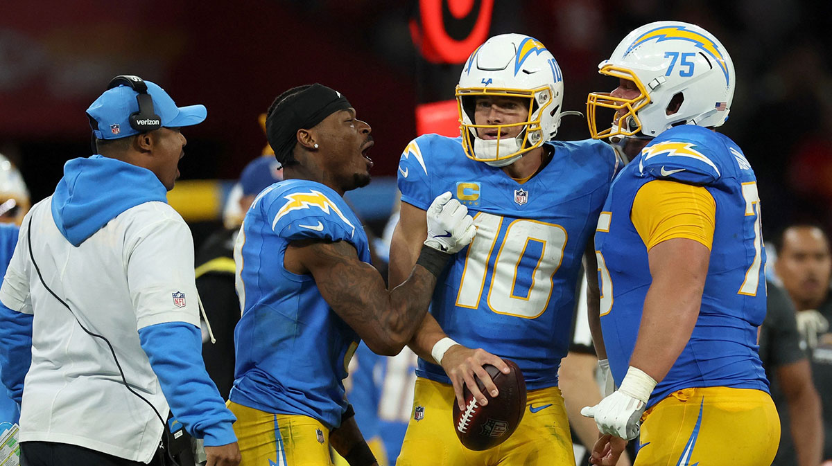 Los Angeles Chargers quarterback Justin Herbert (10) and center Bradley Bozeman (75) celebrate after the game against the Kansas City Chiefs at Corinthians Arena.