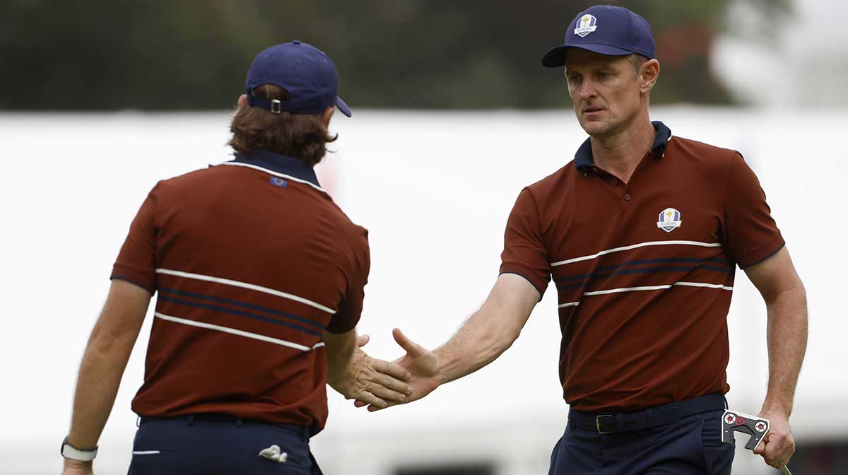 Team Europe golfer Justin Rose and Team Europe golfer Tommy Fleetwood celebrate after making a putt on the 15th hole on the penultimate day of competition for the Ryder Cup at Bethpage Black.