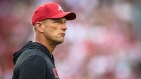 Alabama Crimson Tide head coach Kalen DeBoer watches warm ups on the field before a game against the Georgia Bulldogs at Bryant-Denny Stadium.