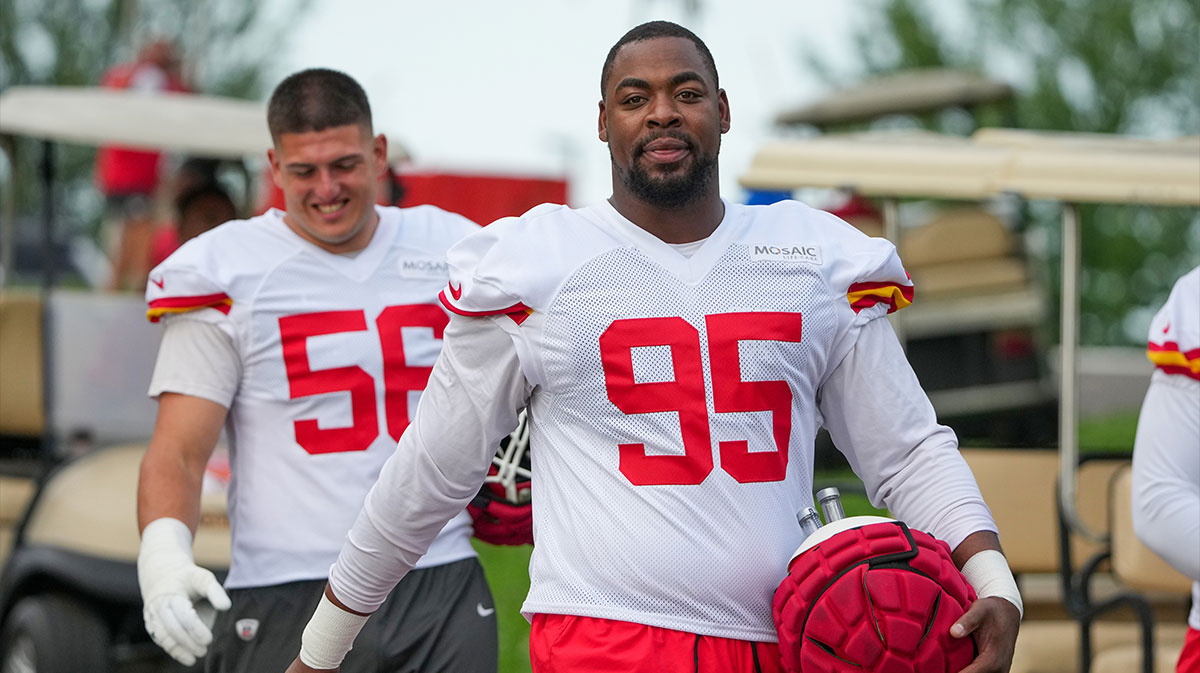 Kansas City Chiefs defensive end George Karlaftis (56) and defensive tackle Chris Jones (95) walk down the hill to the practice fields during training camp at Missouri Western State University.