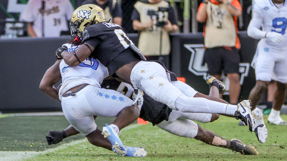 Carolina Tar Heels running back Demon June (35) is tackled by UCF Knights linebacker Keli Lawson (0) during the second quarter at the Bounce House Stadium.