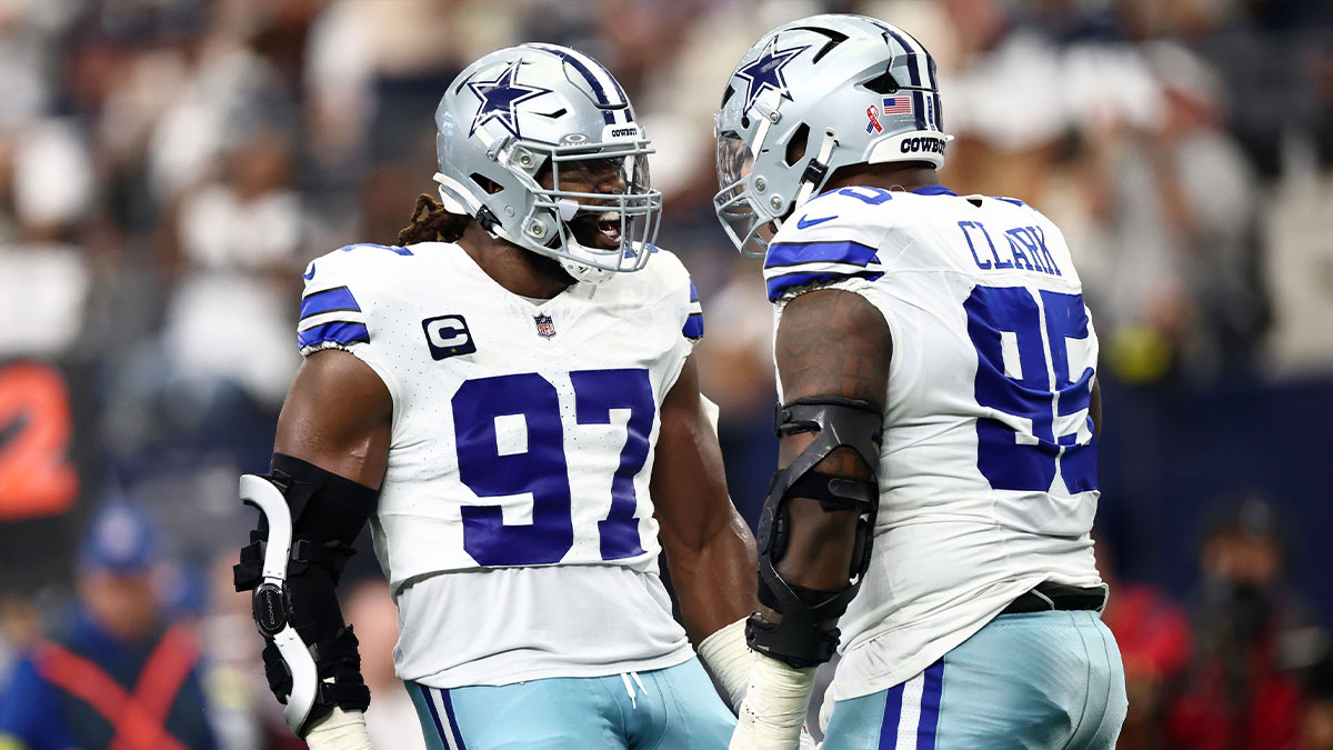 Dallas Cowboys defensive tackle Osa Odighizuwa (97) celebrates with defensive tackle Kenny Clark (95) after a play against the New York Giants during the second quarter at AT&T Stadium.