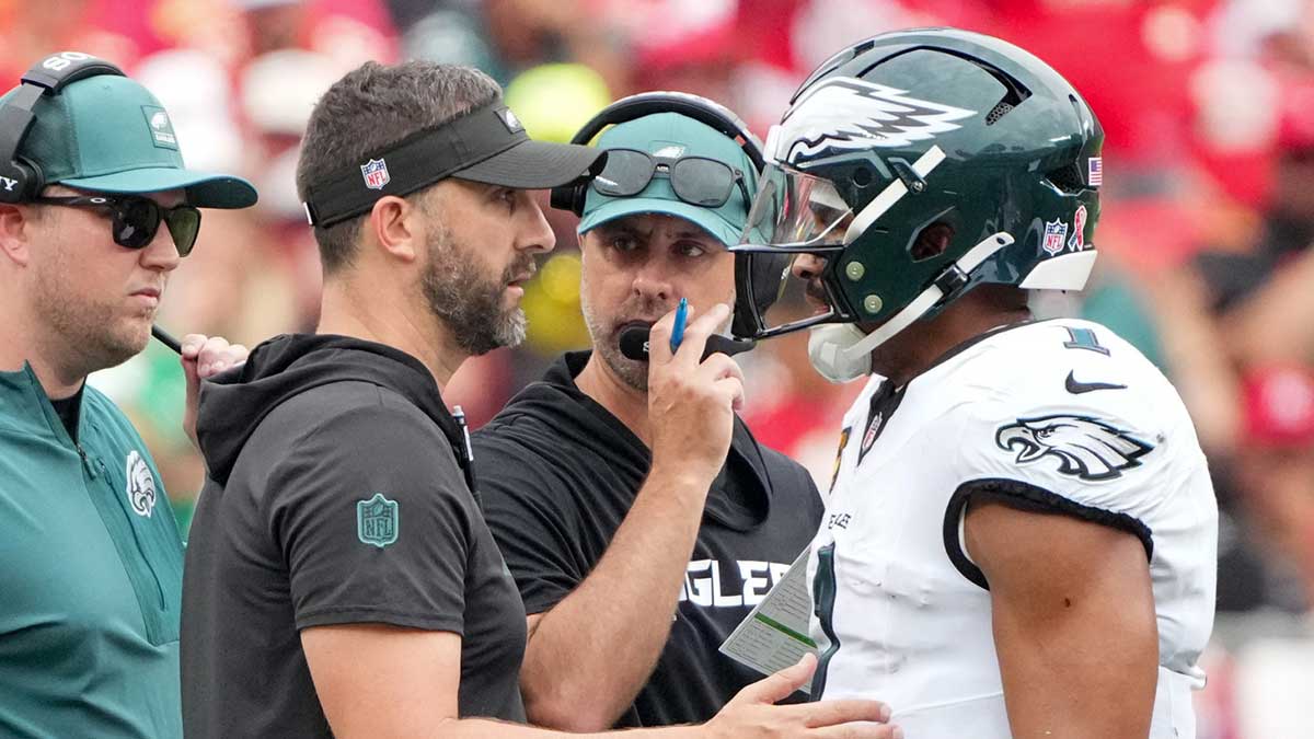 Philadelphia Eagles head coach Nick Sirianni and offenisve coordinator Kevin Patullo speak with Philadelphia Eagles quarterback Jalen Hurts (1) during the second quarter of the game against the Kansas City Chiefs at GEHA Field at Arrowhead Stadium.