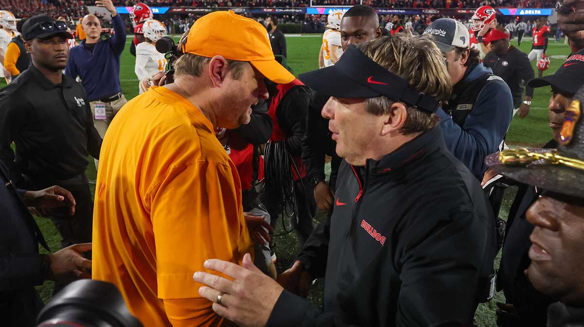 Tennessee Volunteers head coach Josh Heupel talks to Georgia Bulldogs head coach Kirby Smart after a game at Sanford Stadium.