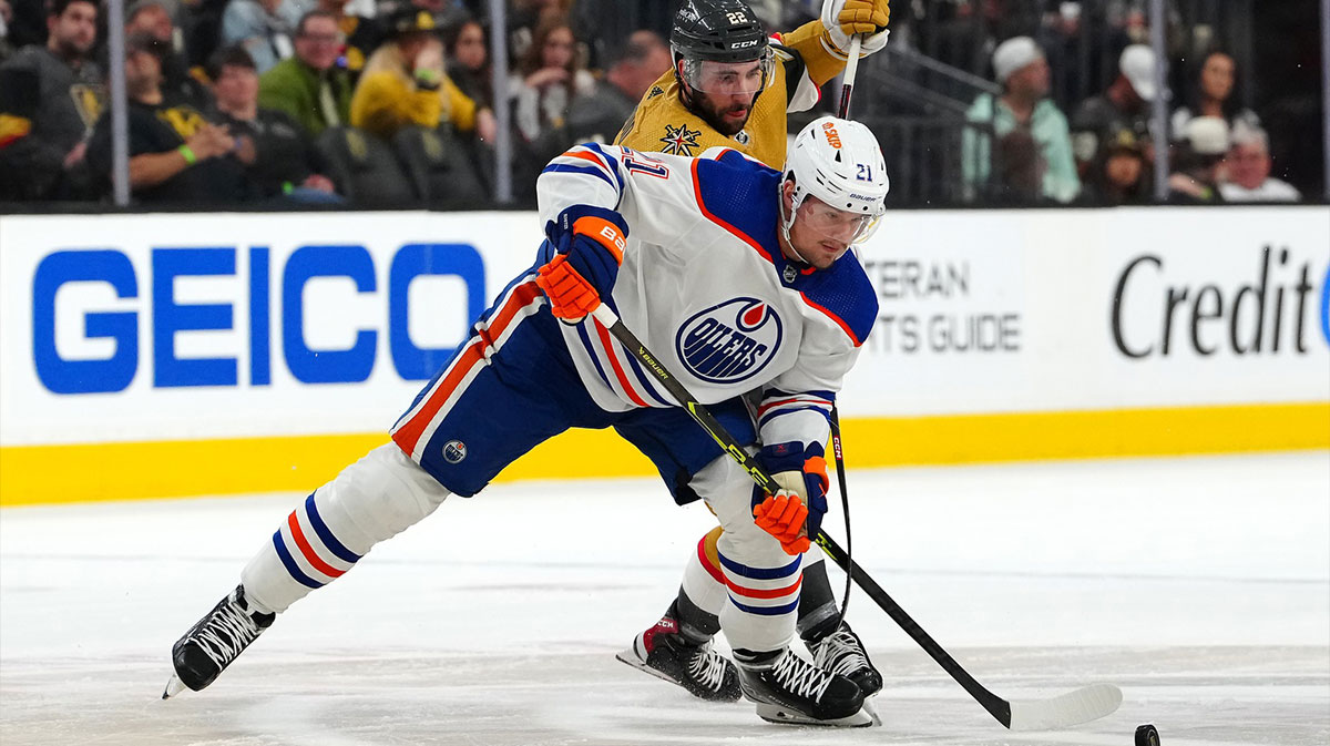 Edmonton Oilers center Klim Kostin (21) keeps the puck away from Vegas Golden Knights right wing Michael Amadio (22) during the second period of game two of the second round of the 2023 Stanley Cup Playoffs at T-Mobile Arena.