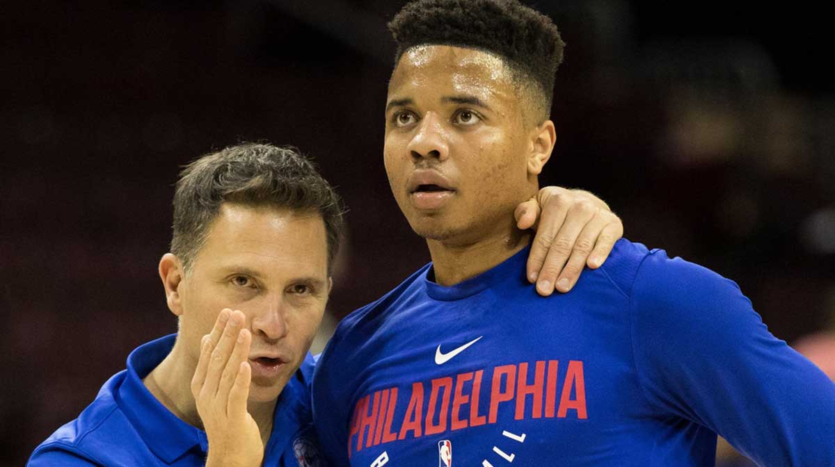 Philadelphia 76ers assistant coach Billy Lange (L) talks with guard Markelle Fultz (R) before a game against the Orlando Magic at Wells Fargo Center.