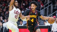 Nov 29, 2024; Atlanta, Georgia, USA; Atlanta Hawks guard Kobe Bufkin (4) drives the ball towards the goal against Cleveland Cavaliers guard Donovan Mitchell (45) during the first quarter at State Farm Arena. Mandatory Credit: Jordan Godfree-Imagn Images