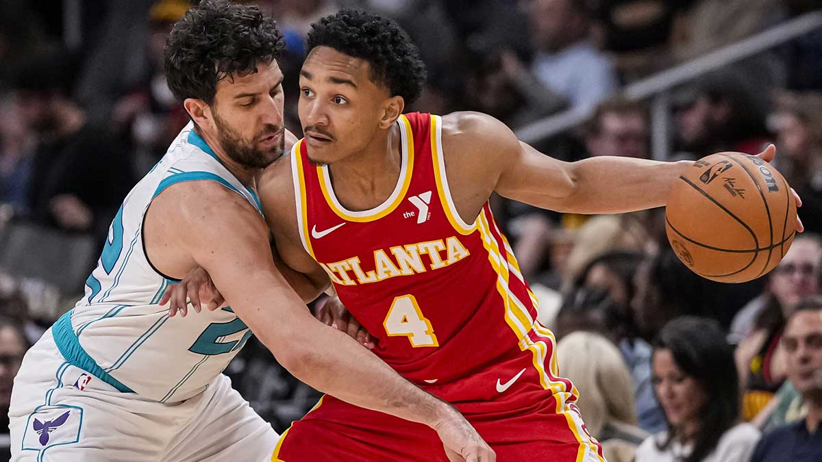 Atlanta Hawks guard Kobe Bufkin (4) is defended by Charlotte Hornets guard Vasilije Micic (22) during the second half at State Farm Arena.