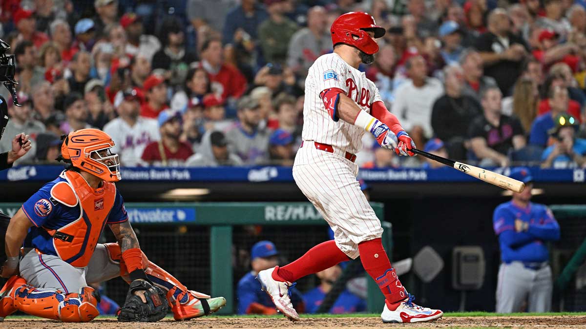 Sep 9, 2025; Philadelphia, Pennsylvania, USA; Philadelphia Phillies outfielder Kyle Schwarber (12) hits his 50th home run of the year during the seventh inning against the New York Mets at Citizens Bank Park. 