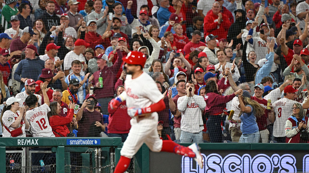 Fans react as Philadelphia Phillies outfielder Kyle Schwarber (12) runs the bases after hitting his 50th home run of the season during the seventh inning against the New York Mets at Citizens Bank Park.