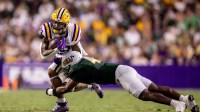 LSU Tigers running back Caden Durham (29) runs against Southeastern Louisiana Lions linebacker Jirrea Johnson Jr. (43) during the first half at Tiger Stadium.