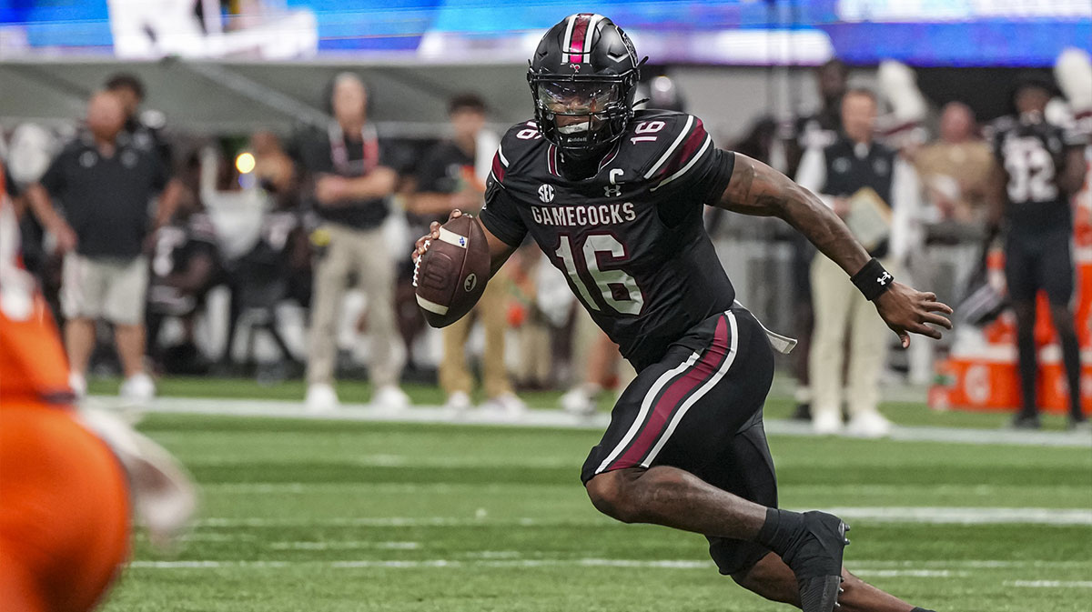 South Carolina Gamecocks quarterback LaNorris Sellers (16) rolls out of the pocket against the Virginia Tech Hokies during the first half at Mercedes-Benz Stadium.