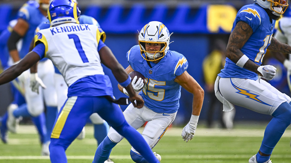 Los Angeles Chargers wide receiver Ladd McConkey (15) runs the ball against Los Angeles Rams cornerback Derion Kendrick (1) during the first quarter at SoFi Stadium. Mandatory Credit: Jonathan Hui-Imagn Images
