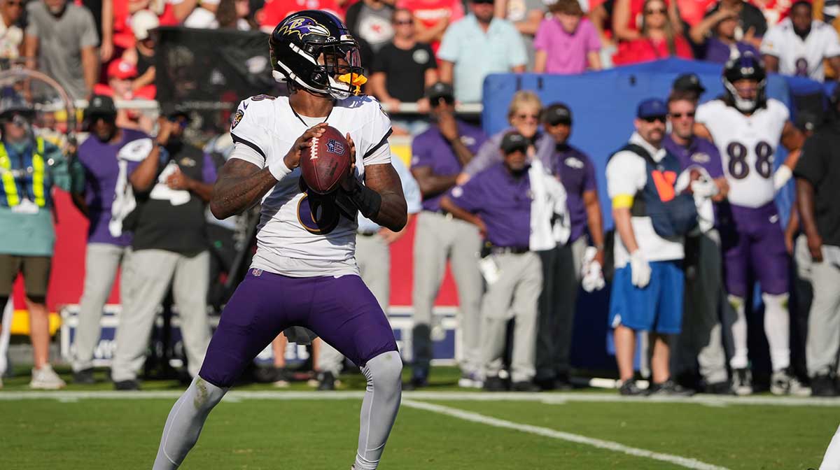 Baltimore Ravens quarterback Lamar Jackson (8) drops back to pass during the first half against the Kansas City Chiefs at GEHA Field at Arrowhead Stadium.