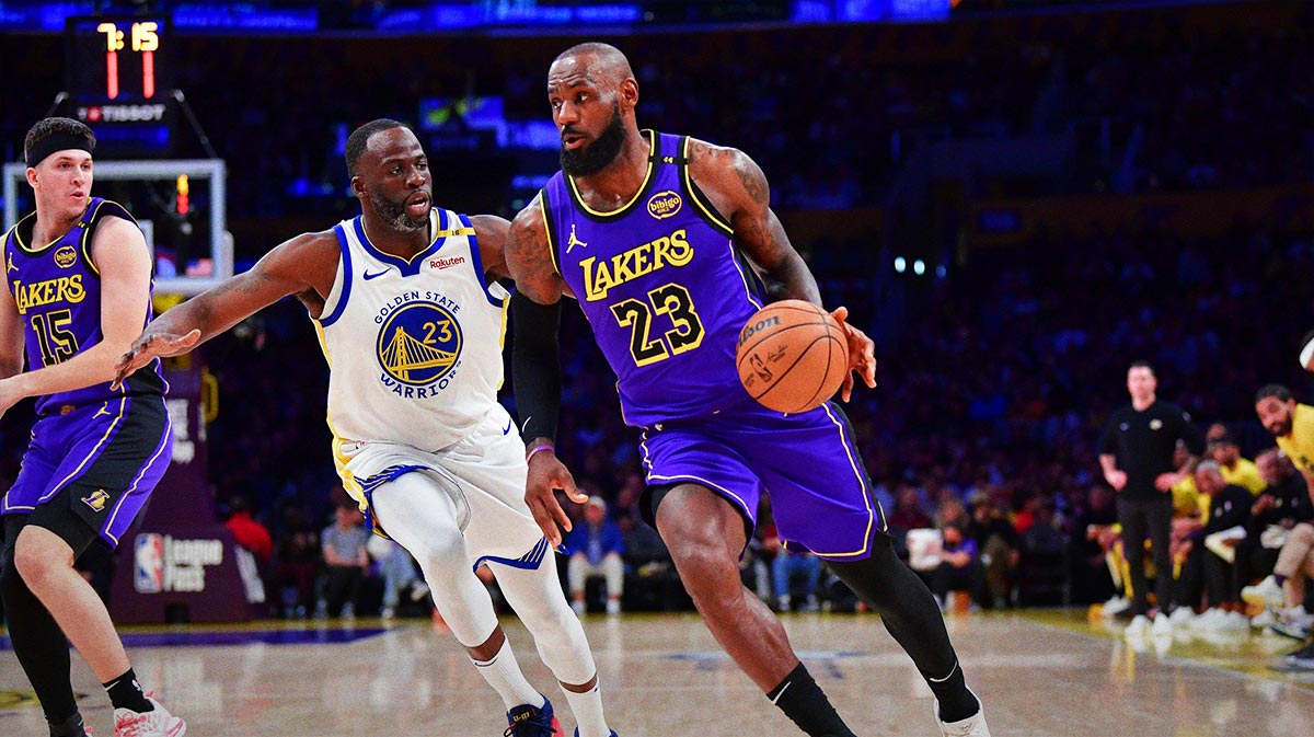  Los Angeles Lakers forward LeBron James (23) moves the ball against Golden State Warriors forward Draymond Green (23) during the first half at Crypto.com Arena.