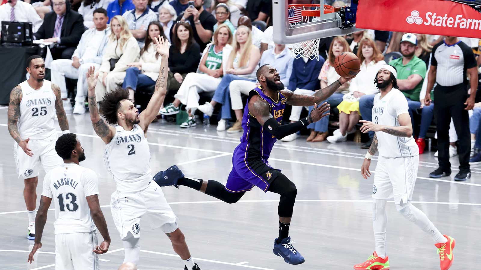 Los Angeles Lakers forward LeBron James (23) shoots past Dallas Mavericks center Dereck Lively II (2) and Dallas Mavericks forward Anthony Davis (3) during the second half at American Airlines Center. 