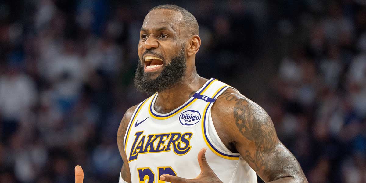Los Angeles Lakers forward LeBron James (23) talks with his coach during a stoppage in play against the Minnesota Timberwolves in the second quarter during game four of first round for the 2025 NBA Playoffs at Target Center.