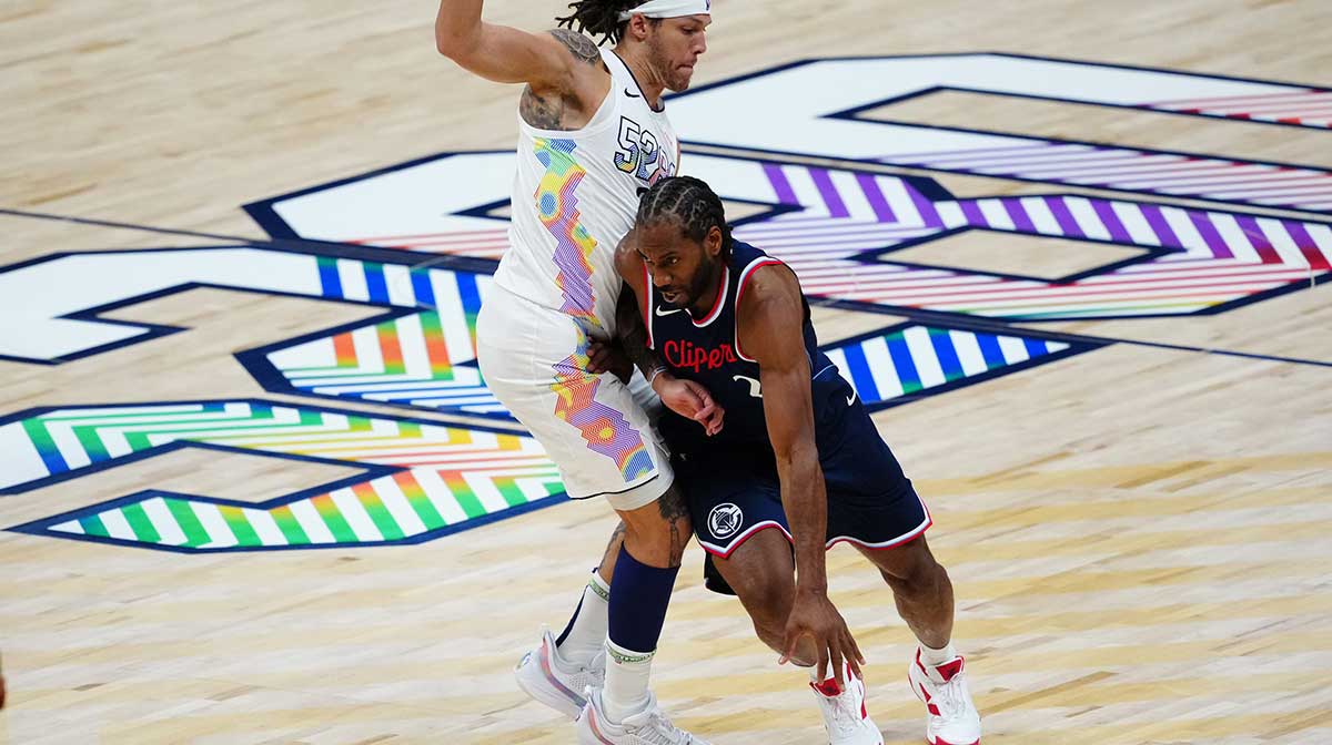 LA Clippers forward Kawhi Leonard (2) drives past Denver Nuggets forward Aaron Gordon (32) in the second quarter during five of first round for the 2025 NBA Playoffs at Ball Arena.