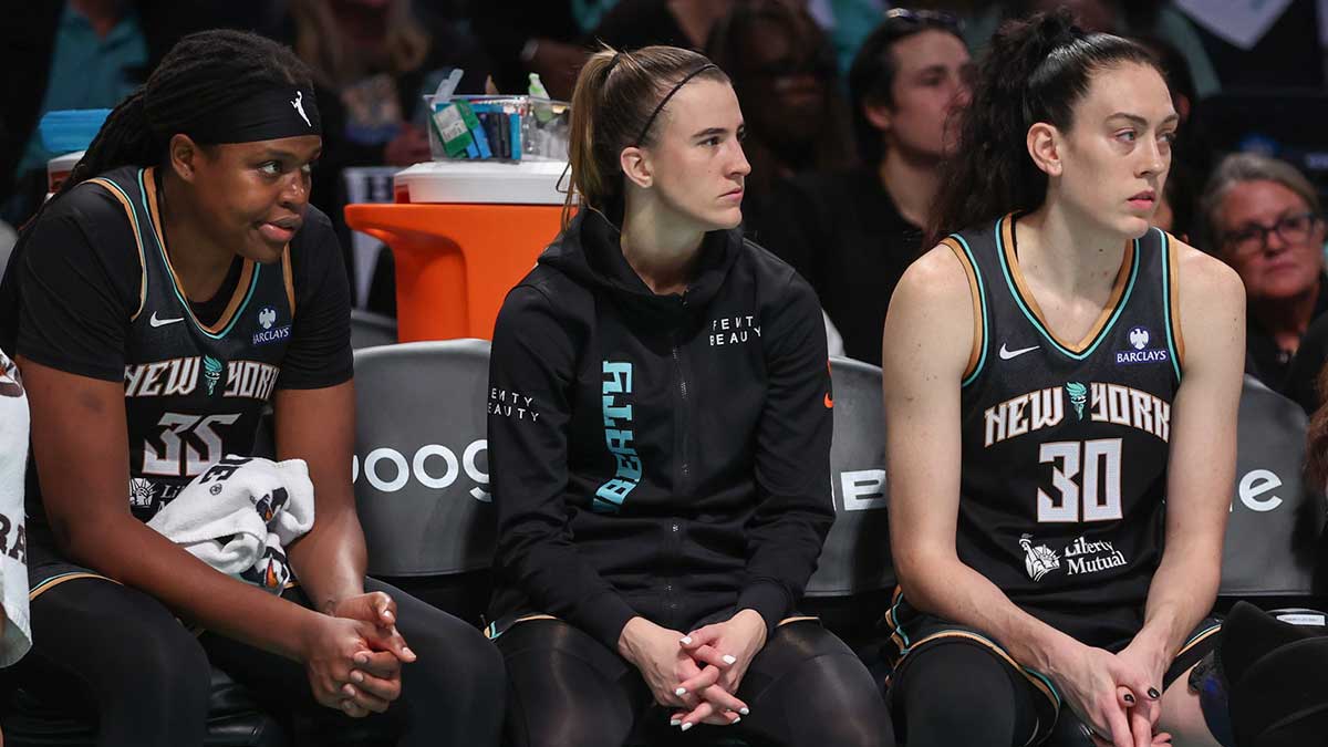New York Liberty center Jonquel Jones (35), guard Sabrina Ionescu (20), and forward Breanna Stewart (30) watch from the bench against the Phoenix Mercury during game two of round one for the 2025 WNBA Playoffs at Barclays Center.