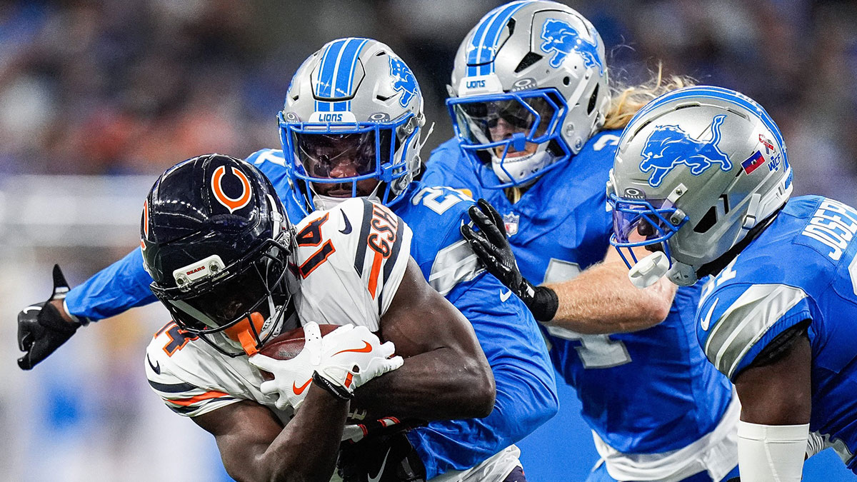 Detroit Lions cornerback Amik Robertson (21), left, linebacker Alex Anzalone (34) and safety Kerby Joseph (31) tackle Chicago Bears wide receiver Olamide Zaccheaus (14) during the first half.