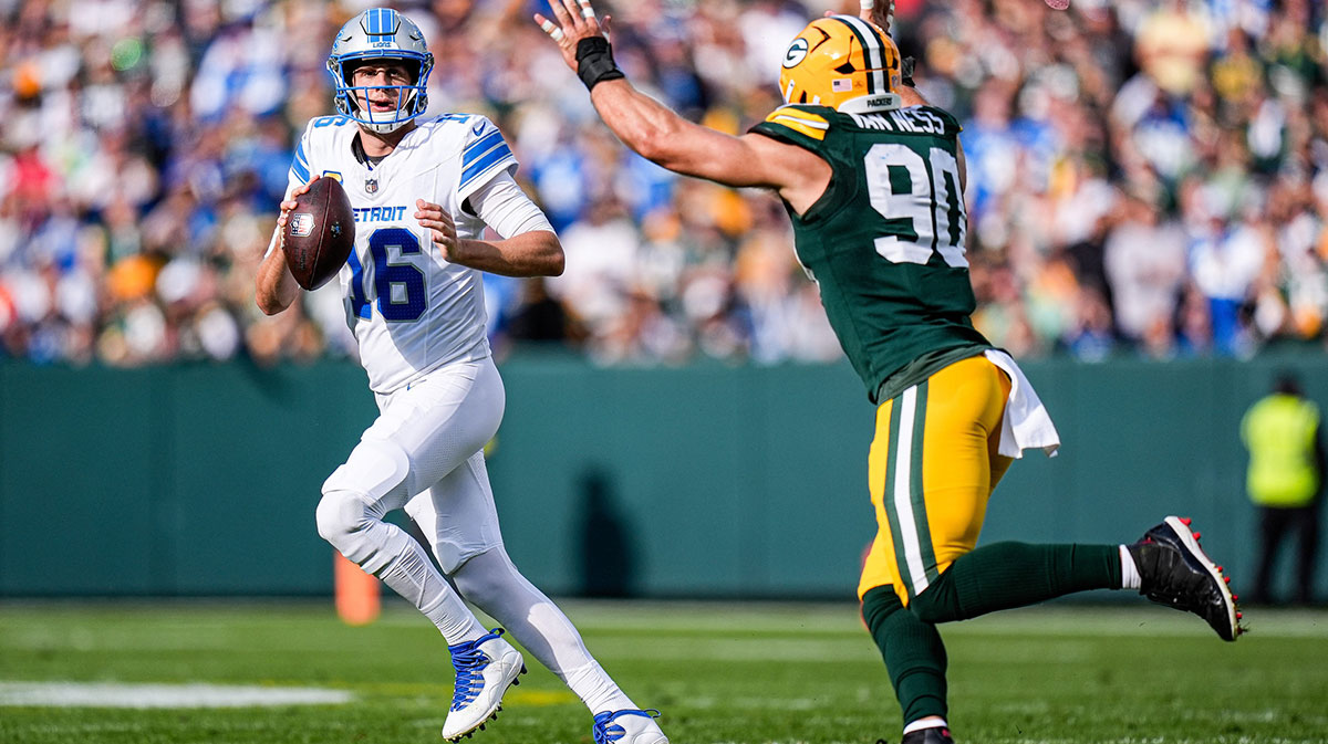 Detroit Lions quarterback Jared Goff (16) looks to pass against Green Bay Packers defensive end Lukas Van Ness (90) during the first half at Lambeau Field in Green Bay, Wis., on Sunday, September 7, 2025.