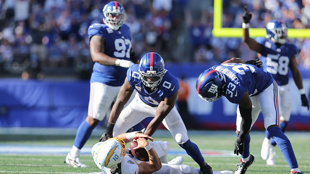 Los Angeles Chargers quarterback Justin Herbert (10) is sacked by New York Giants linebacker Brian Burns (0) during the fourth quarter at MetLife Stadium.