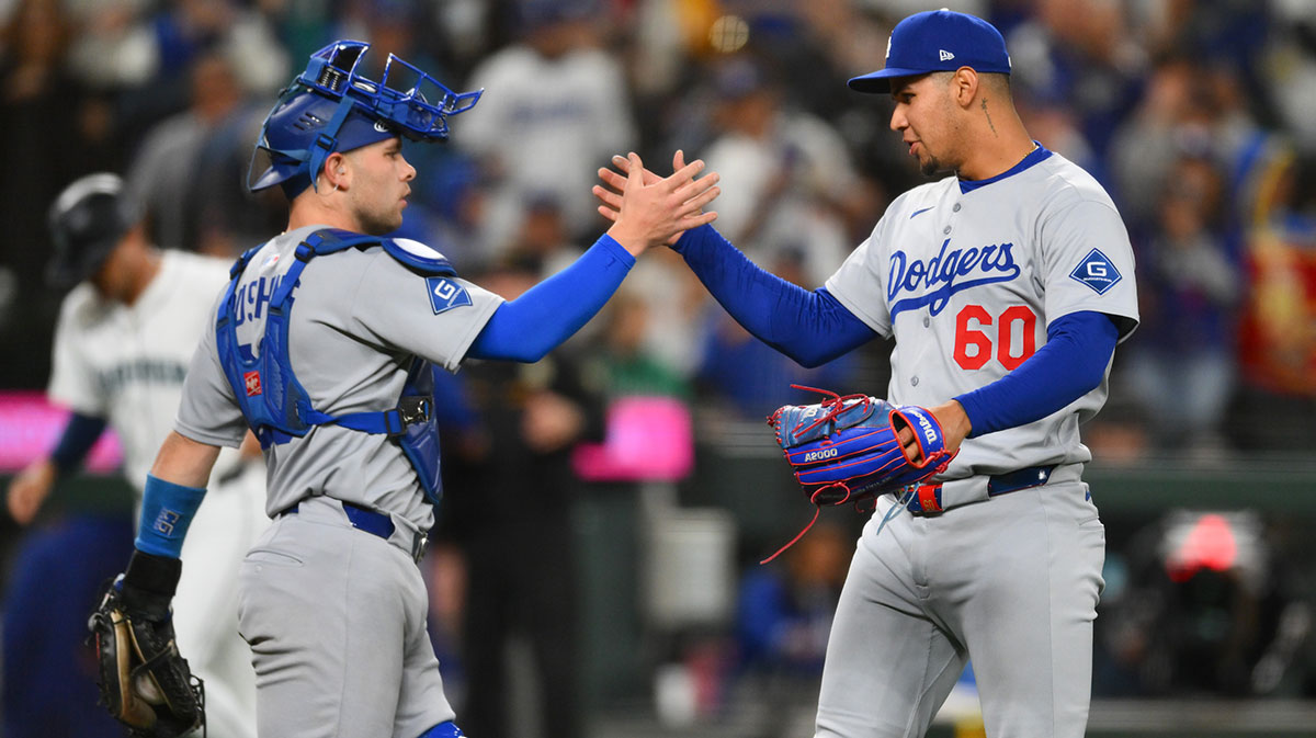 Los Angeles Dodgers catcher Dalton Rushing (68) and relief pitcher Edgardo Henriquez (60) celebrate defeating the Seattle Mariners at T-Mobile Park.