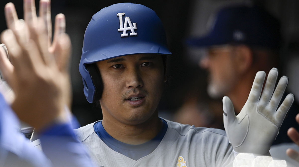 Los Angeles Dodgers designated hitter Shohei Ohtani (17) celebrates with teammates in the dugout after hitting a third inning solo home run against the Baltimore Orioles at Oriole Park at Camden Yards.