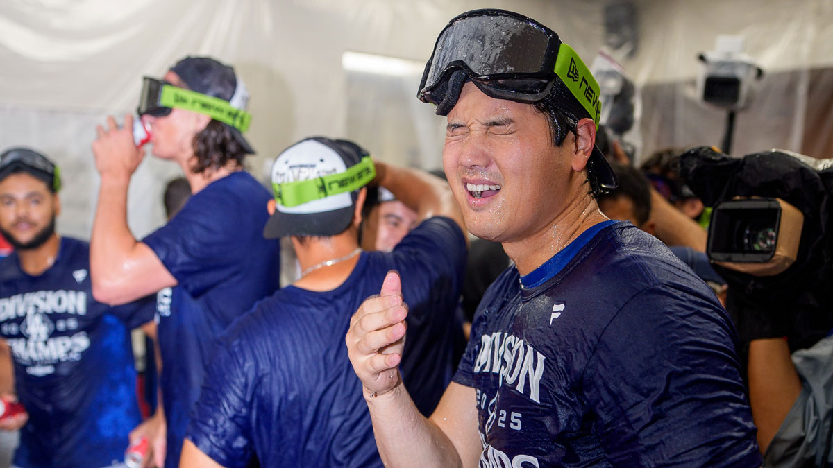 Los Angeles Dodgers designated hitter Shohei Ohtani (17) reacts after getting beer in his eyes as he celebrates with his team after winning the National League West championship follow a game against the Arizona Diamondbacks at Chase Field. Mandatory Credit: Allan Henry-Imagn Images