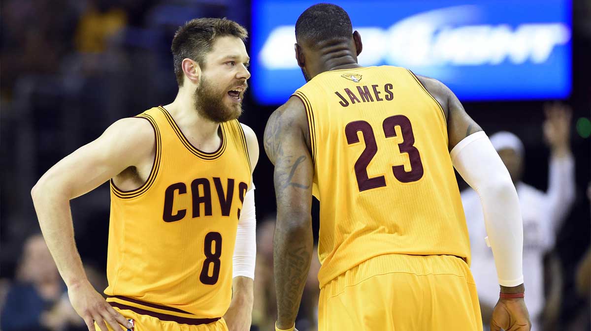 Cleveland Cavaliers guard Matthew Dellavedova (8) talks with forward LeBron James (23) during the first quarter against the Golden State Warriors in game three of the NBA Finals at Quicken Loans Arena.