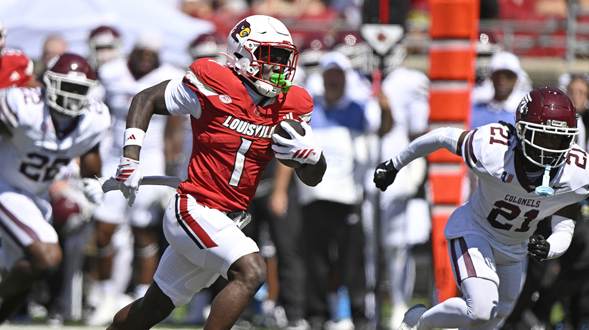 Louisville Cardinals running back Isaac Brown (1) runs the ball against Eastern Kentucky Colonels defensive back Rishad Hence (21) during the first quarter at L&N Federal Credit Union Stadium.