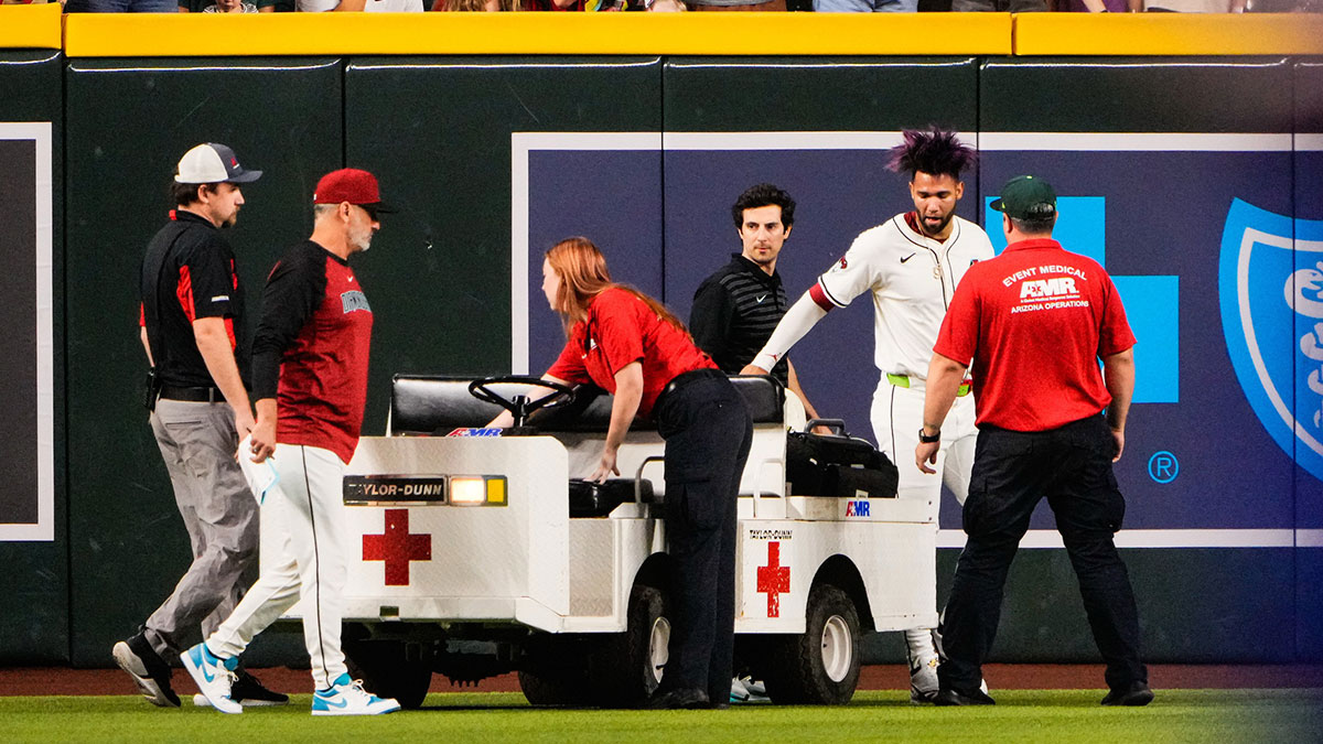 Arizona Diamondbacks outfielder Lourdes Gurriel Jr. (12) is loaded on a cart after colliding with Arizona Diamondbacks centerfielder Blaze Alexander (9) in the outfield in the sixth inning during the game between the Texas Rangers and Arizona Diamondbacks.