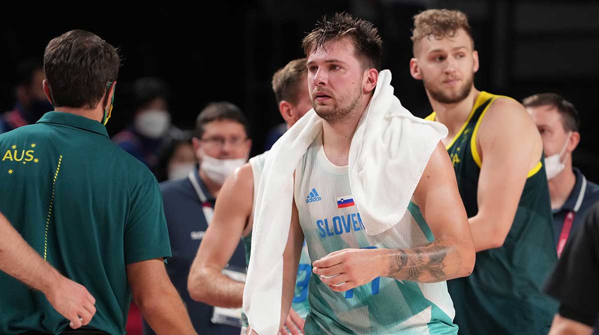 Team Slovenia point guard Luka Doncic (77) shakes hands with Australia players and coaches after their game during the Tokyo 2020 Olympic Summer Games at Saitama Super Arena.