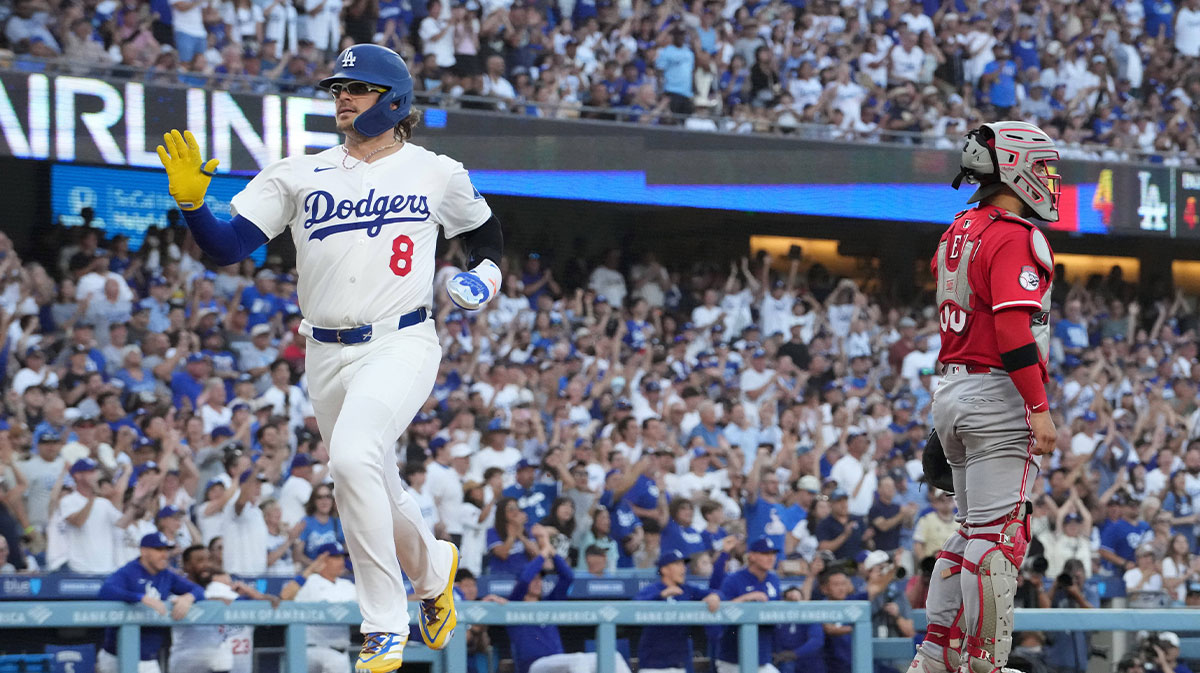 Los Angeles Dodgers first baseman Kike Hernandez (8) crosses home plate to score in the fourth inning as Cincinnati Reds catcher Jose Trevino (35) watches at Dodger Stadium.