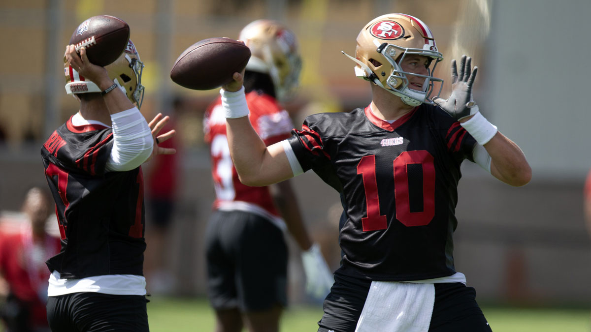 San Francisco 49ers quarterbacks Brock Purdy (13) and Mac Jones (10) work on passing drills during the first day of training camp at SAP Performance Facility.