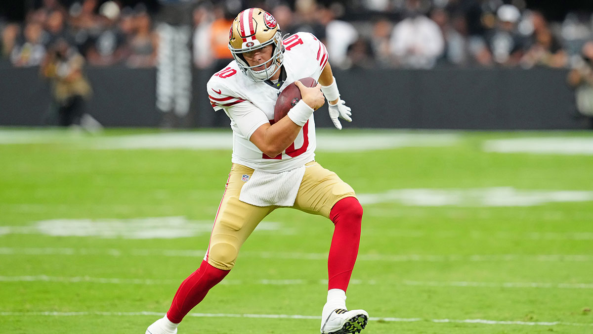 San Francisco 49ers quarterback Mac Jones (10) rushes against the Las Vegas Raiders during the second quarter at Allegiant Stadium.