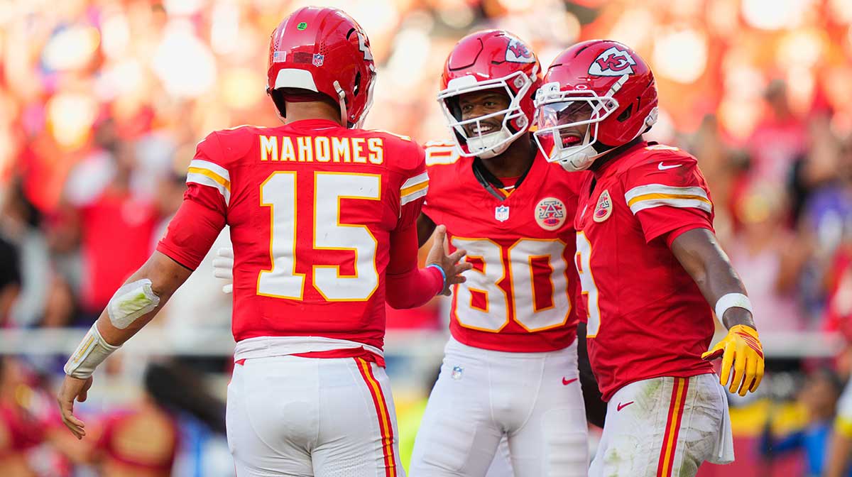 Kansas City Chiefs wide receiver Tyquan Thornton (80) celebrates with Kansas City Chiefs quarterback Patrick Mahomes (15) and Kansas City Chiefs wide receiver JuJu Smith-Schuster (9) after scoring a touchdown during the third quarter at GEHA Field at Arrowhead Stadium.