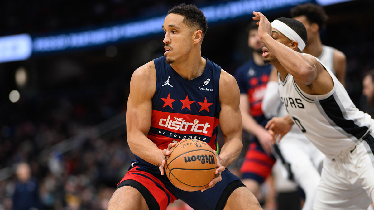 Washington Wizards guard Malcolm Brogdon (15) drives to the basket against San Antonio Spurs forward Keldon Johnson (0) during the second quarter at Capital One Arena.
