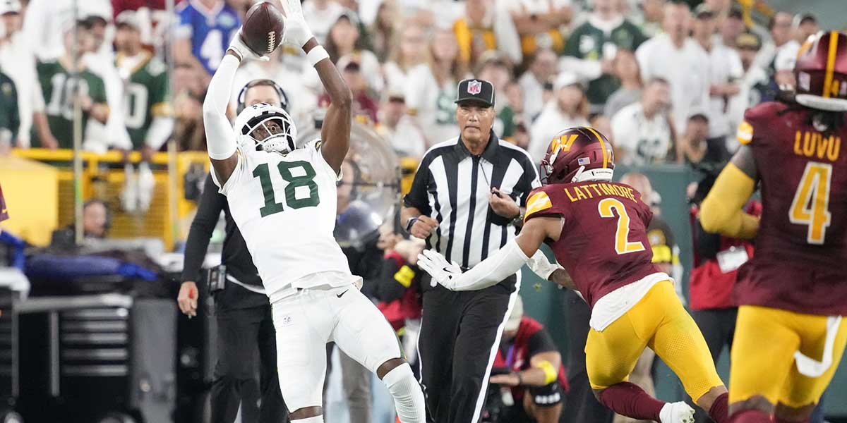 Green Bay Packers wide receiver Malik Heath (18) makes a catch against Washington Commanders cornerback Marshon Lattimore (2) in the second quarter at Lambeau Field.