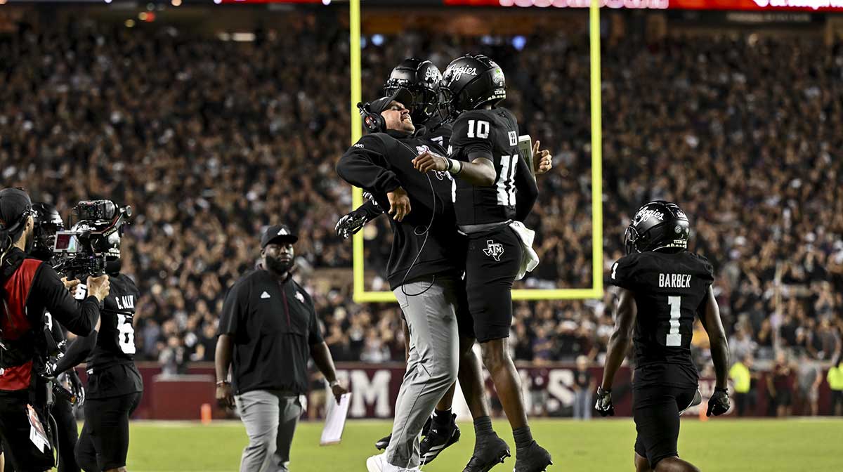 Texas A&M Aggies quarterback Marcel Reed (10) celebrates after scoring a touchdown with Offensive Coordinator/Quarterbacks coach Collin Klein in the third quarter against the LSU Tigers at Kyle Field.